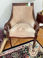 Front view of Bombay Company armchair showing beige upholstery and wood frame