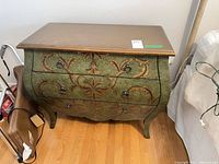 Full front view of three-drawer bombe dresser showing painted finish and hardware