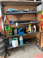 Full shelving unit showing assortment of car chemicals, fluids and tools