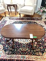 Top view of oval wood coffee table on rug