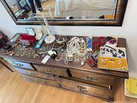 Full dresser top view showing majority of jewelry pieces spread out