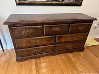 Front view of seven-drawer dresser showing drawer arrangement and hardware