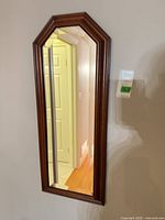 Front view of mirror showing wood frame and glass