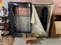 Two garment racks side by side, shoe-rack parts box with hangers in front