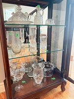 Cabinet shelves with assorted pressed glass pieces