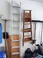 Both ladders hanging on wall