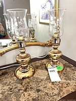 Front view of both brass lamps and shades