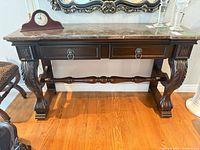 Front view of marble top hall table showing overall design and drawers