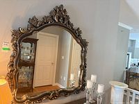 Full view of ornate framed wall mirror on wall