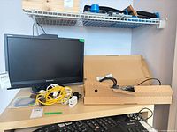 Lenovo monitor, Dell keyboard, extension cord, cables on desk