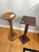 Two wooden pedestals side by side showing overall design and height comparison