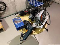 Overall group of drill, circular saw, grinder and drill bits