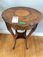 Top view showing inlaid leaf motif and scalloped edge