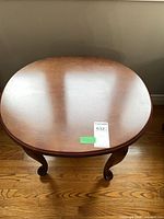 Top view of round wood side table showing veneer surface
