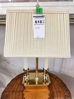 Front view showing complete lamp with shade and brass base