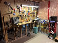 overall view of workbench, pegboard and hanging tools