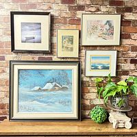Group shot of all six framed artworks displayed on wall
