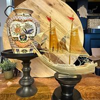 Full view of vase and acrylic ship side by side on stands