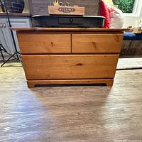 Front view of solid wood chest showing plank front and recessed base