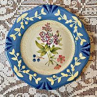 Front of Flora pattern plate showing floral centre and blue embossed rim