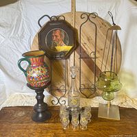 Full group shot showing decanter set, glasses, pitcher, portrait frame, plate racks, hanging vessel