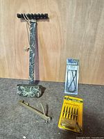 Group shot of quiver, slingshot frame, packaged broadheads and crossbow string