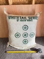 Front view showing Whitetail Series by Arrow Brake logo and five green target circles, tape measure indicating size