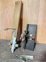 Overall view of wood board with jig, gauge base, loose clamp