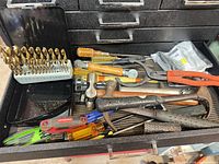Drawer view showing drill bits, hammers, pliers, screwdrivers, hex key set and bagged hardware