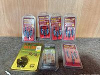 All seven sealed packages displayed—five Allen Lightning broadheads, one Allen orange broadhead pack, one Quick Shot accessory