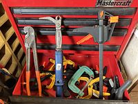 Drawer with multiple clamps including bar clamp, C-clamp, spring clamps, pliers and blue screw fixture