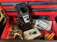 Drawer view with clamp meter, tap & die set, hole saw kit, nut driver pouch, goggles