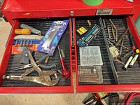 Overview of both tool-chest drawers with diverse hand tools, drill bits, Havalon knife package visible