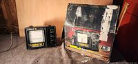 Front view of Eagle Mach 1 Computer Graph fish finder beside original box