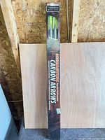 Full view of unopened Easton carbon arrows box leaning against wall