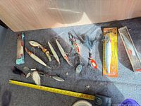 Group shot of all lures with tape measure for scale