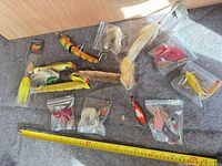 All lures arranged with tape measure for scale
