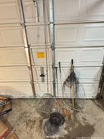 Group shot of five fishing nets leaning against garage door