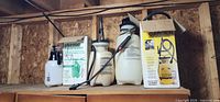 Shelf with small hand sprayer, RB2000 box, two loose tank sprayers, Lawn & Garden boxed sprayer