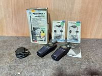 Full lot showing radios, charger, manual, Motorola box, packaged headsets