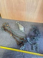 Overview of pulley and two chains with tape measure for scale