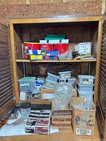 Full view of cabinet with hardware containers on two shelves