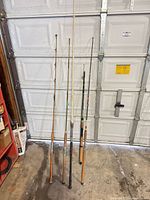 All five rods leaning against garage door