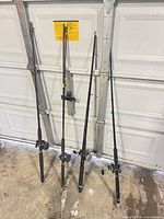 Four rods standing against door, three with reels visible