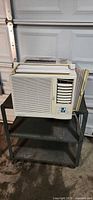 Front view of Simplicity window air conditioner on metal cart