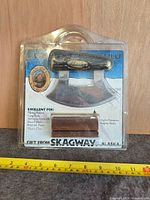 Front of sealed package showing ulu knife and stand