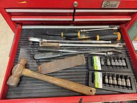 Drawer view with hammer, chisels, ratchet, breaker bar, extensions, file and socket sets