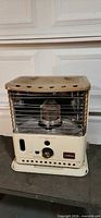 Full front view of cream Sunbeam kerosene heater