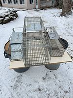All three wire live traps on table, size comparison visible