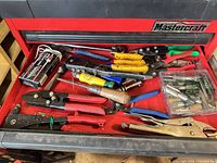 Drawer view of assorted pliers, crimpers, snips and bit box